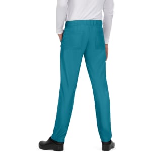 Turquoise pants with a soft waistband and pockets, viewed from the back. The model is wearing black shoes.