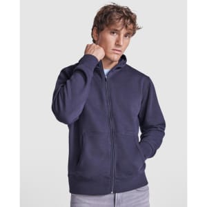 A navy hooded sweatshirt featuring a zip closure and front pockets, modeled by a young man. It has a logo on it.