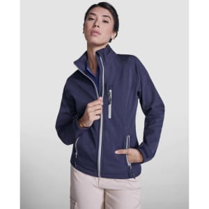 A women's softshell jacket in navy blue, featuring a high collar and zippered pockets, with branding visible.
