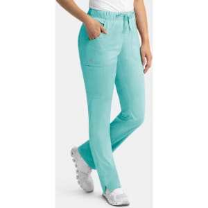 A pair of aqua women's cargo pants with a full elastic waistband and multiple pockets, worn with white shoes.
