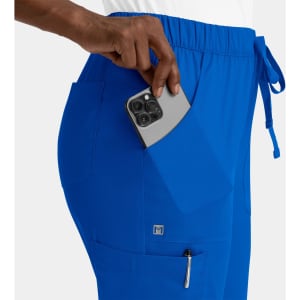 A pair of bright blue cargo pants with an elastic waistband, featuring side pockets and a hand holding a phone.