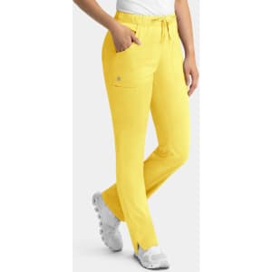 Yellow cargo pants with a full elastic waistband and pockets, paired with a white top and white footwear.