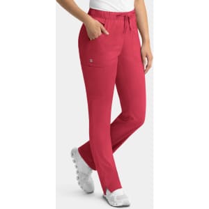 Red women's cargo pants featuring a full elastic waistband and side pockets, modelled by a person in white shoes.
