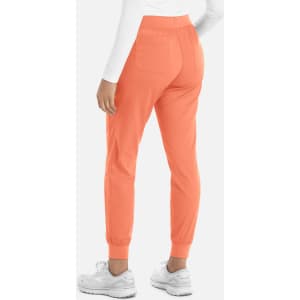 A pair of women's joggers in a bright coral colour, featuring a tapered design and elastic waistband.