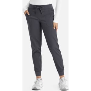 A pair of women's jogger-style pants in a dark grey colour, featuring a drawstring waist and side pockets.