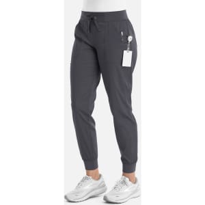 A pair of grey women's joggers with a tapered leg and elastic waistband, featuring pockets and a logo.