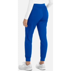 A pair of women's joggers in vibrant blue, featuring a fitted waist and tapered legs, worn with white shoes.