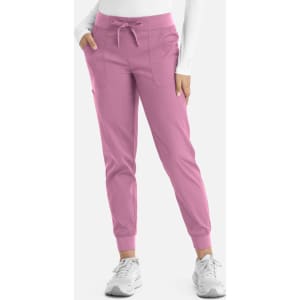 A pair of women's joggers in light pink, featuring a drawstring waist and side pockets, with a branding logo.