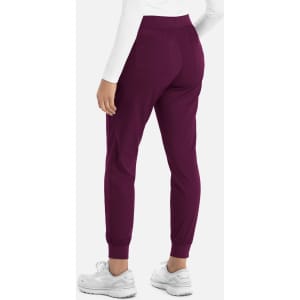 A pair of women's joggers in dark purple, featuring an elastic waistband and cuffs, with a branding logo.