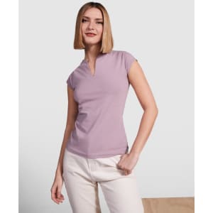 A lilac T-shirt with a V-neck and short sleeves, worn by a model with straight hair and a neutral background.