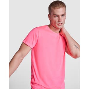 A bright pink t-shirt featuring a crew neckline, showcased on a model with a casual pose. The shirt has a logo.