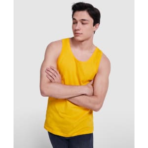 A young man in a bright yellow tank top with a casual pose and crossing his arms. The top has a logo.