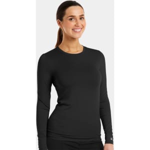 A black long-sleeve underscrub tee is displayed on a smiling model. The tee has a fitted design and a logo.