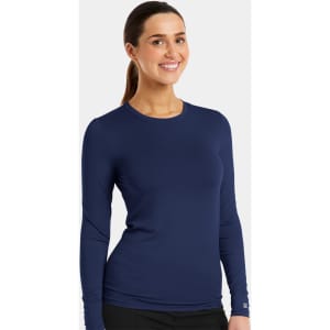 A model wearing a long-sleeve navy underscrub tee, featuring a fitted design and a logo.