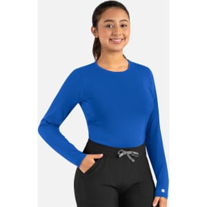 A long-sleeved blue underscrub tee paired with black pants, featuring a logo on the sleeve.