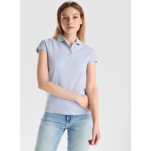 A light blue women's polo shirt with a collar and short sleeves, featuring a logo on the chest area.