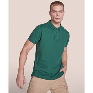 A green polo shirt featuring a collar and button placket, worn by a model. The shirt has a logo on it.