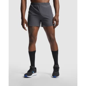 Sporty grey running shorts with an elastic waistband and branding, paired with black socks and footwear.
