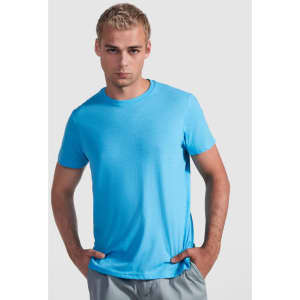 A blue t-shirt with a round neck, worn by a model posing with hands on his hips. The shirt has a logo.