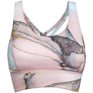 A cropped tank top in pastel pink with abstract blue and gold designs, featuring a cross-back style and a logo.