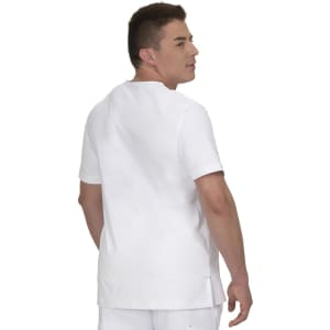 A white short-sleeved shirt worn by a man, featuring a simple design and a logo on the back.