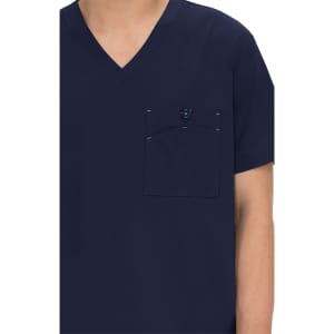 A navy blue medical scrub top featuring a chest pocket and stitching details. It includes a logo on the pocket.