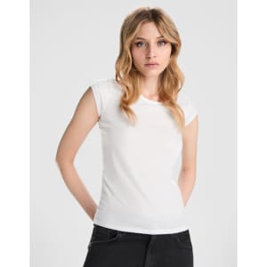 A fitted white T-shirt featuring short sleeves, paired with black jeans. The shirt has a branding logo.