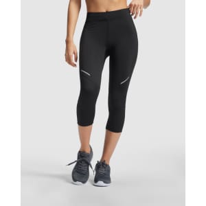 Black mid-length leggings featuring reflective accents, paired with grey athletic shoes. The leggings have a sleek, fitted design.