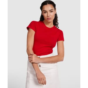 A red women's t-shirt with short sleeves, paired with a white skirt, displayed on a model.