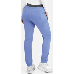 A pair of women's cargo pants in light blue with an elastic waistband and pockets, featuring a logo.