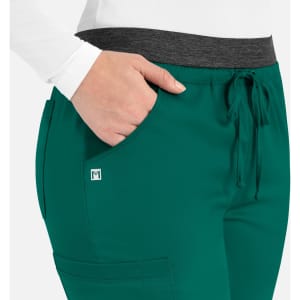 Women's cargo pants in teal with a contrasting grey waistband and pocket details. Features a logo on the fabric.
