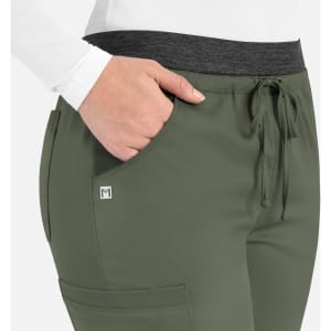 A close-up of women's cargo pants in olive green with a contrast waistband and a side pocket. Features a small logo.
