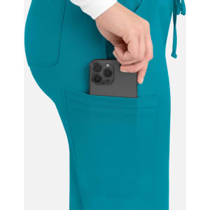 A pair of teal cargo pants with a phone snugly fitted in the back pocket. The pants feature a drawstring waistband and logo.