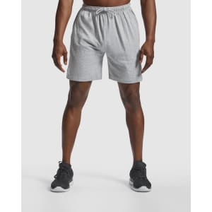 Grey sports shorts with an elastic waistband, featuring a logo, suitable for athletic wear.