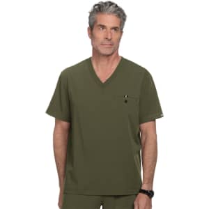 A man in a green scrubs top, featuring a V-neck and a pocket. The scrubs have a logo on the front.