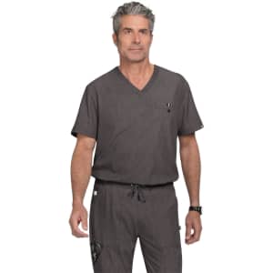 A man wearing a grey scrubs set with a V-neck top and drawstring pants, featuring a small pocket and branding.