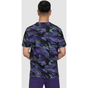 A camouflage t-shirt in shades of purple, black, and grey, featuring a round neckline and short sleeves.