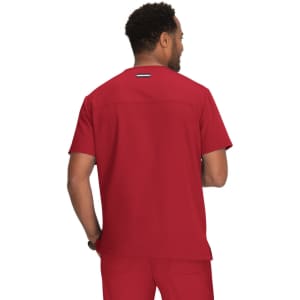 A scrub top in a deep red colour, featuring a simple design and a logo on the back.