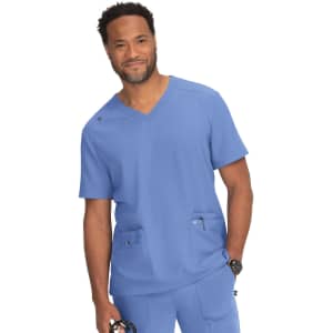 A blue medical scrub top with a v-neck design, featuring two front pockets and a logo on the shoulder.