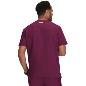 A man wearing a maroon medical scrub top, viewed from the back. The top features a small logo on the upper back.