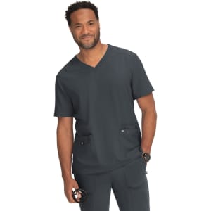 A scrubs top in dark grey, featuring a V-neck design and two front pockets. A man is wearing the garment.
