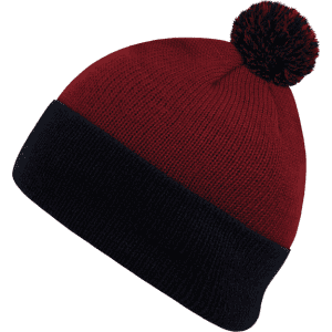 A red and navy beanie featuring a pom pom on top and a fold-over cuff. It has a logo on the cuff.