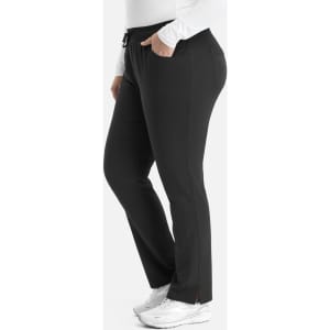A tapered pant in black, featuring a waistband and pockets, displayed on a model wearing a white top.