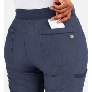 A pair of tapered yoga pants in a navy colour with pockets, featuring a logo on the back pocket.