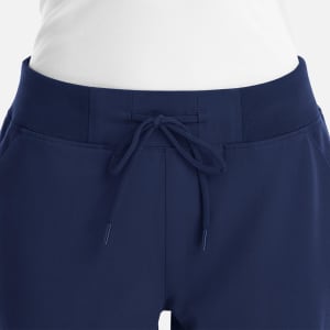 A women's full waist jogger in navy blue featuring a drawstring waistband and side pockets.