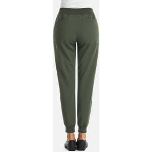 A pair of women's full waist joggers in dark green, featuring two back pockets and a tapered leg design.