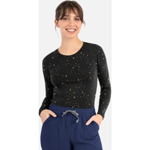 A long-sleeve women's underscrub tee in black with a starry pattern, featuring a fitted design and round neckline.