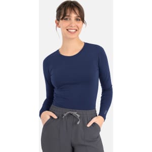 A navy long-sleeve women's underscrub tee with a fitted design, paired with grey trousers.