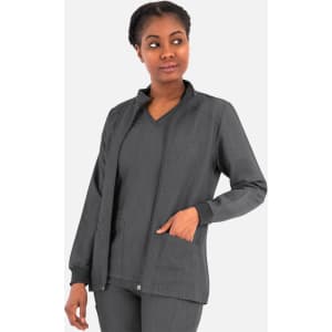 A women's hi collar warm-up jacket in black, featuring a zip front and pockets, modelled by a woman.