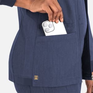 A navy blue women's warm-up jacket with a high collar and a visible pocket holding a smartphone. It features a logo.